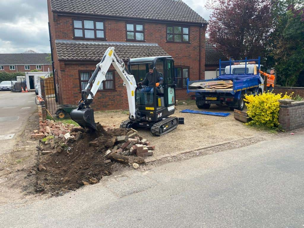 This is a photo of an operative of NS Driveways Camberley Digging out for a new tarmac driveway